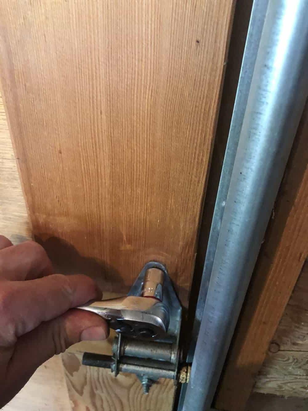 tightening garage door hinge bolt